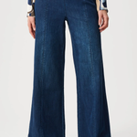 Person wearing blue pants against white background