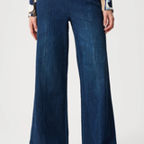 Person wearing blue pants against white background