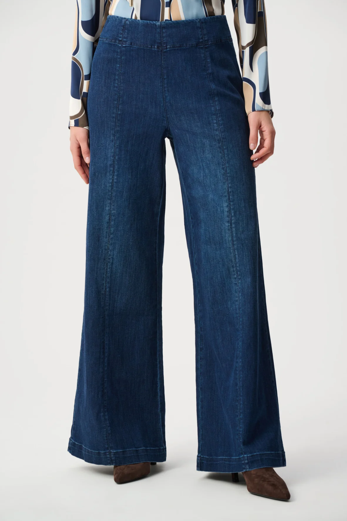 Person wearing blue pants against white background