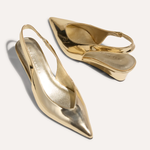 Gold high-heeled shoes on a white background