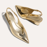 Gold high-heeled shoes on a white background