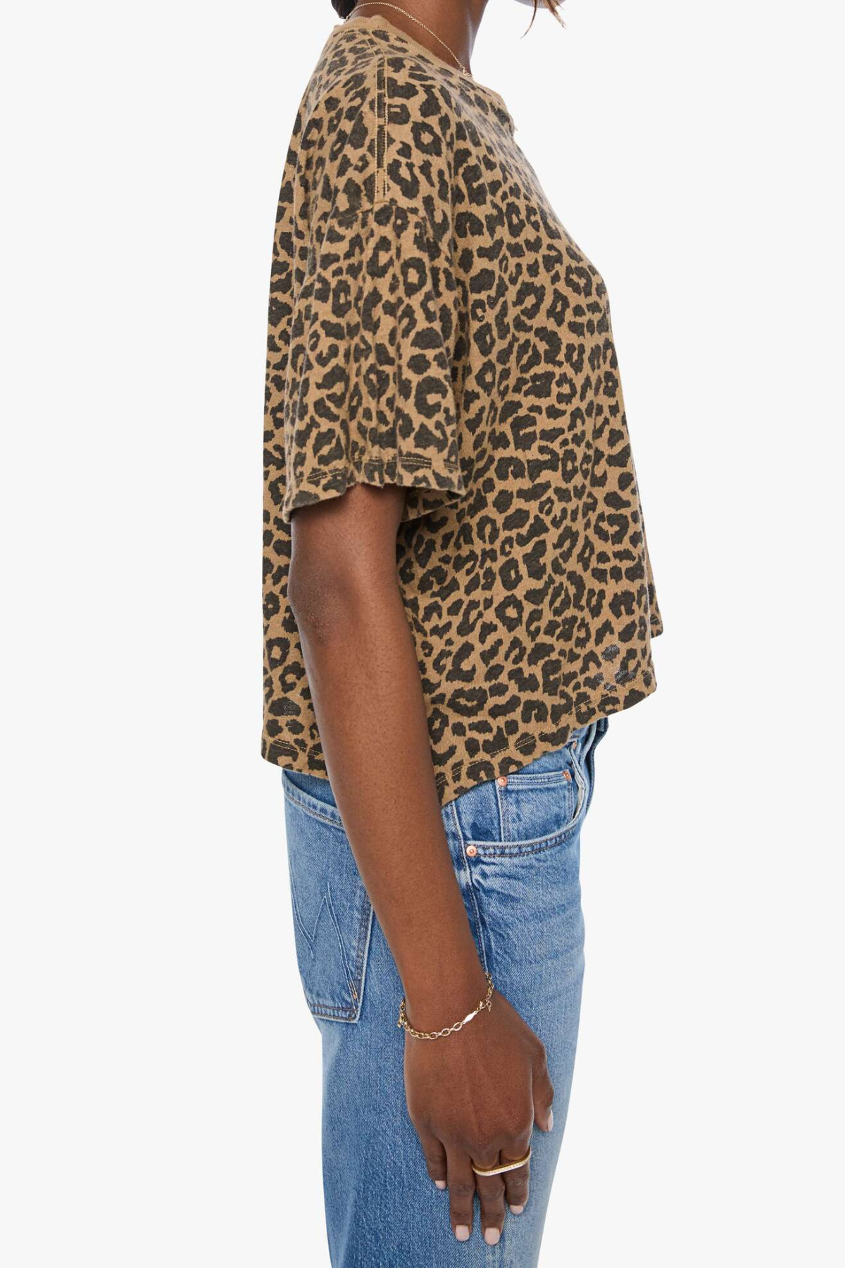 Model wearing a brown striped short-sleeve boxy ringer T-shirt with contrast trim and blue denim.