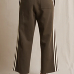 Brown pants with white stripes on a neutral background