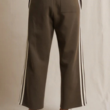 Brown pants with white stripes on a neutral background