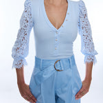 woman in light blue quarter sleeve ribbed and lace blouse 