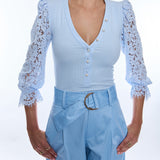 woman in light blue quarter sleeve ribbed and lace blouse 