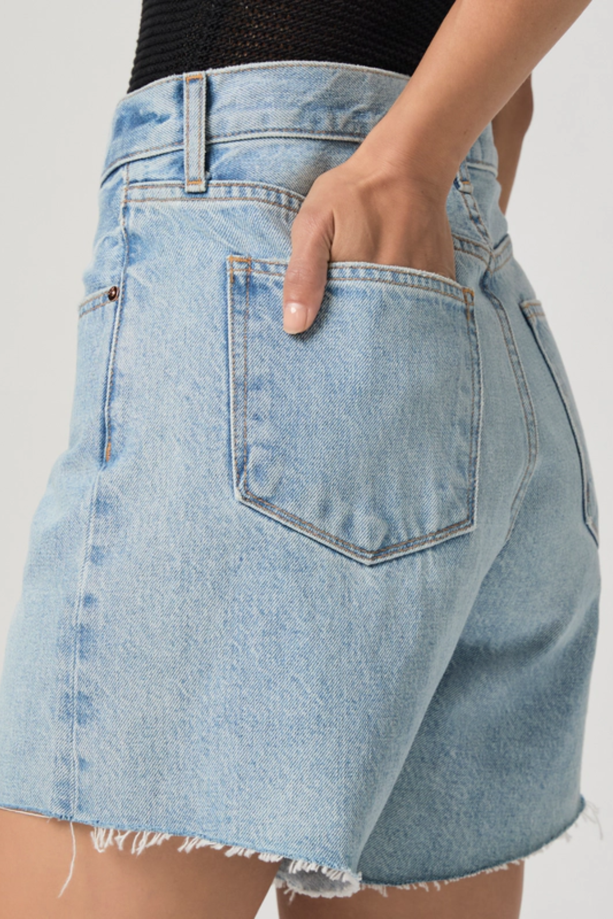 Light blue denim skirt with a white background