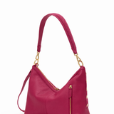 Pink handbag with gold accents on a white background