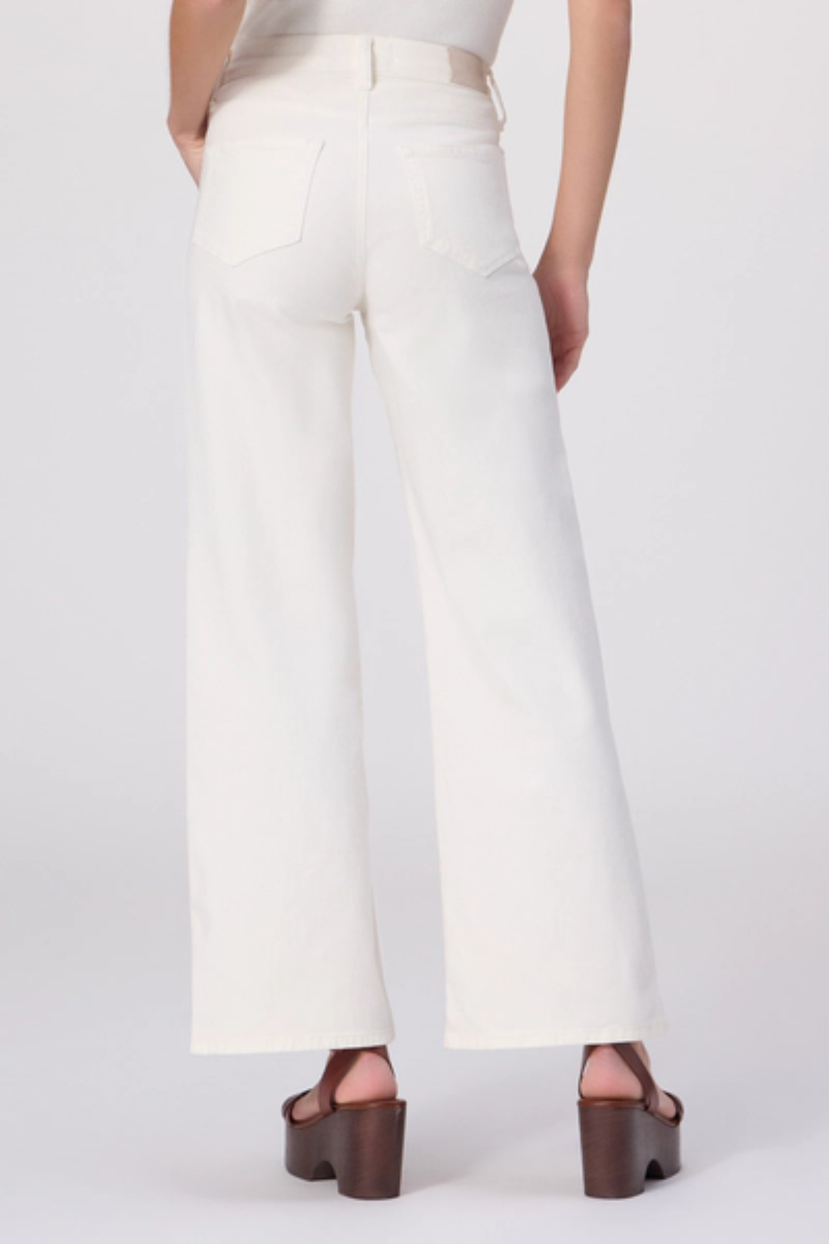 White wide-leg pants worn by a person on a white background