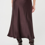 A dark brown satin midi skirt with a crinkled texture, shown on a model from the back against a light gray studio background.