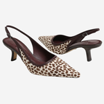 A pair of pointed-toe slingback pumps featuring a brown and beige leopard print pattern with dark brown leather straps and heels, shown against a plain light gray background.