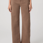 Person wearing brown wide-leg jeans on a plain background