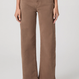Person wearing brown wide-leg jeans on a plain background
