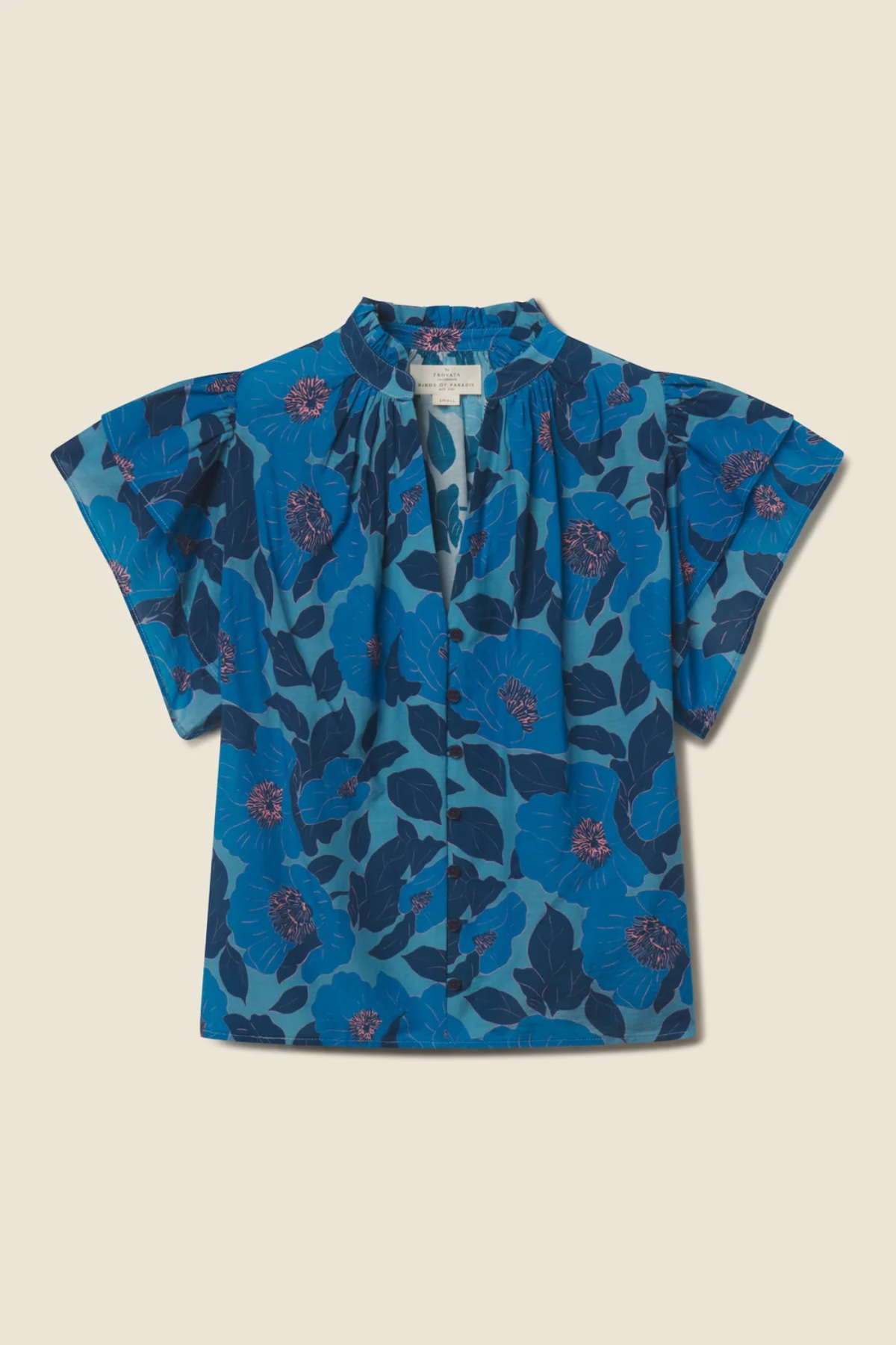 blue floral blouse on tan background 