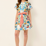 Woman wearing a colorful floral dress on a white background
