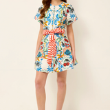 Woman wearing a colorful floral dress on a white background