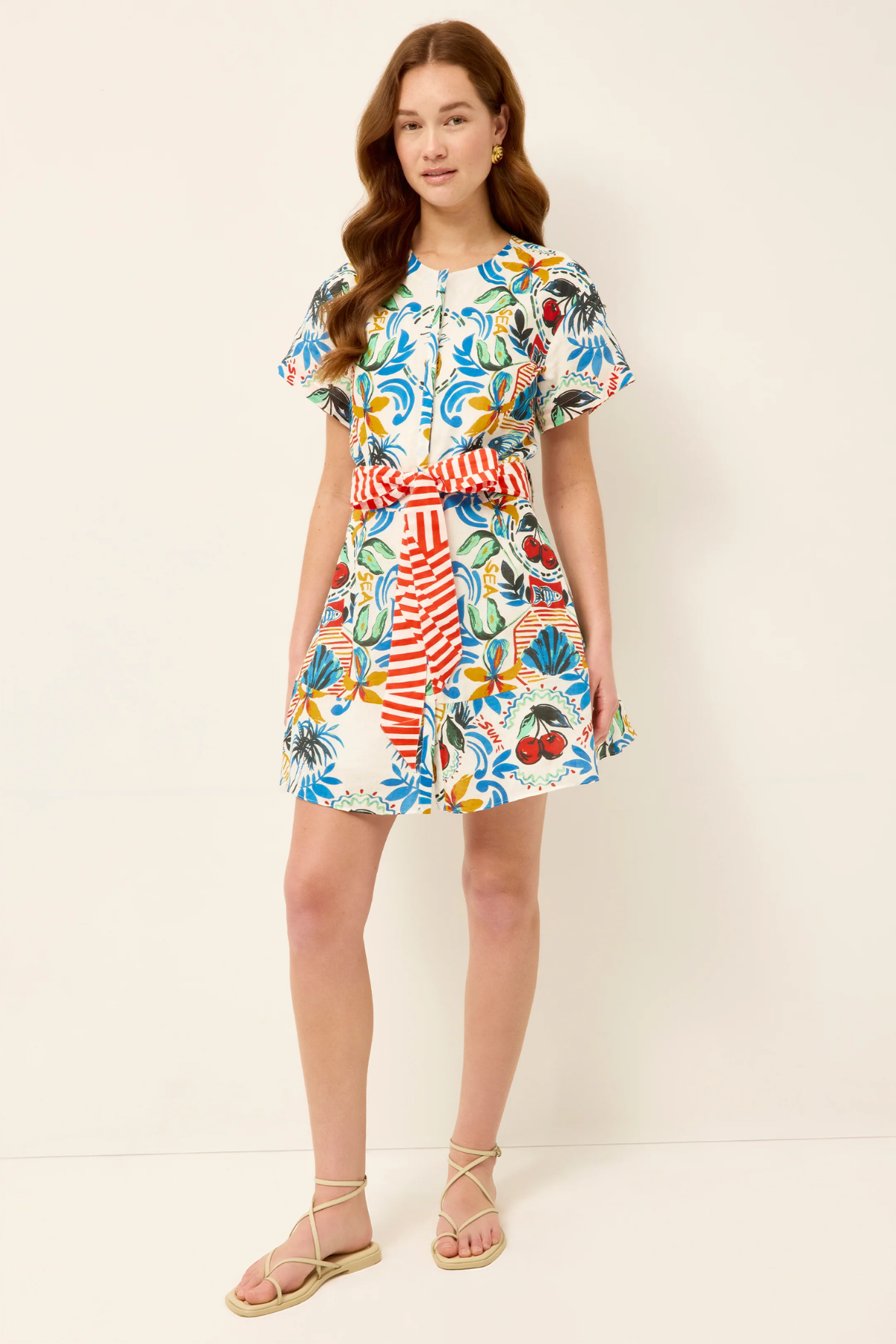 Woman wearing a colorful floral dress on a white background