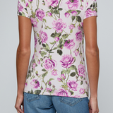 Model wearing rose print tee on a white background.