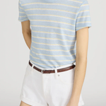 Person wearing a blue and yellow striped t-shirt and white shorts on a plain background