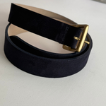 Navy belt with gold buckle on white background