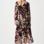 Woman wearing a patterned dress on a white background