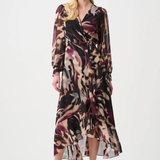Woman wearing a patterned dress on a white background