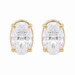 A pair of gold stud earrings featuring large oval-cut clear gemstones in a four-prong setting, shown against a plain white background.