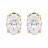 A pair of gold stud earrings featuring large oval-cut clear gemstones in a four-prong setting, shown against a plain white background.
