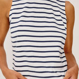 Person wearing a striped tank top with blue and white horizontal stripes on a plain background