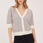 A woman modeling a short-sleeve knit cardigan with thin dark brown horizontal stripes on an off-white base, featuring a V-neck and button-front closure, paired with black pants against a plain light background.