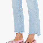 Pink sandals with embellishments worn with light blue jeans on a white background