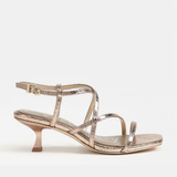 Gold high-heeled sandal on a white background