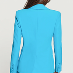 Blue suit jacket worn by a person on a plain background