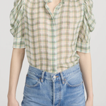 Model wearing a light green printed blouse with a relaxed silhouette
