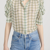 Model wearing a light green printed blouse with a relaxed silhouette