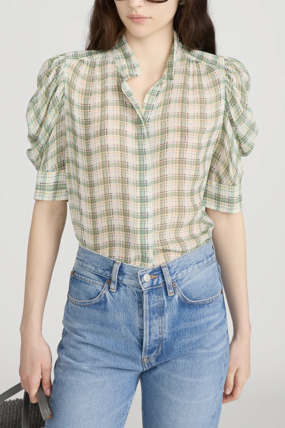 Model wearing a light green printed blouse with a relaxed silhouette