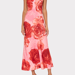 Woman wearing a pink floral dress on a white background