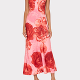 Woman wearing a pink floral dress on a white background