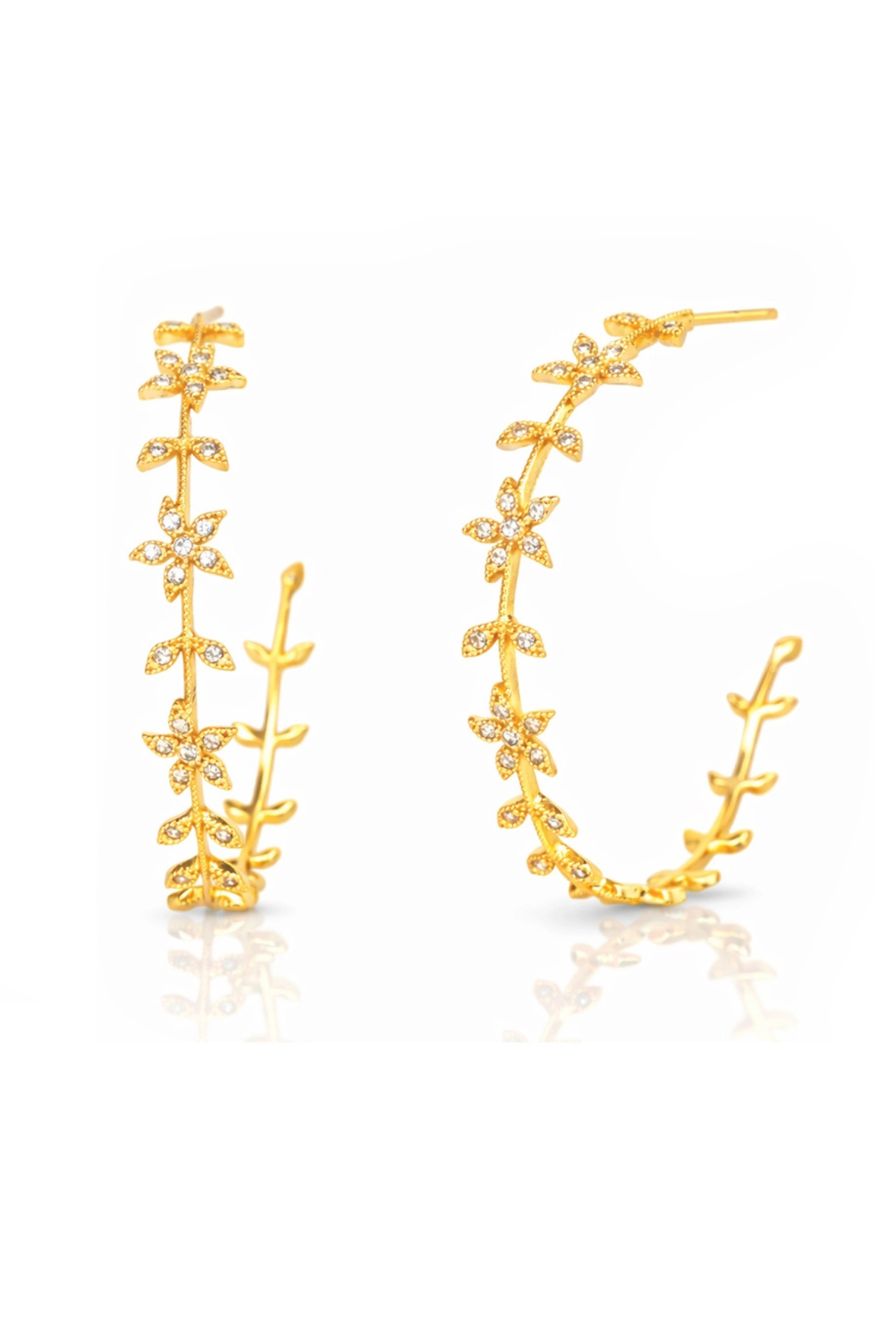 A pair of gold hoop earrings decorated with delicate leaf and flower motifs, embellished with small clear crystals, shown on a clean white background with a soft reflection.