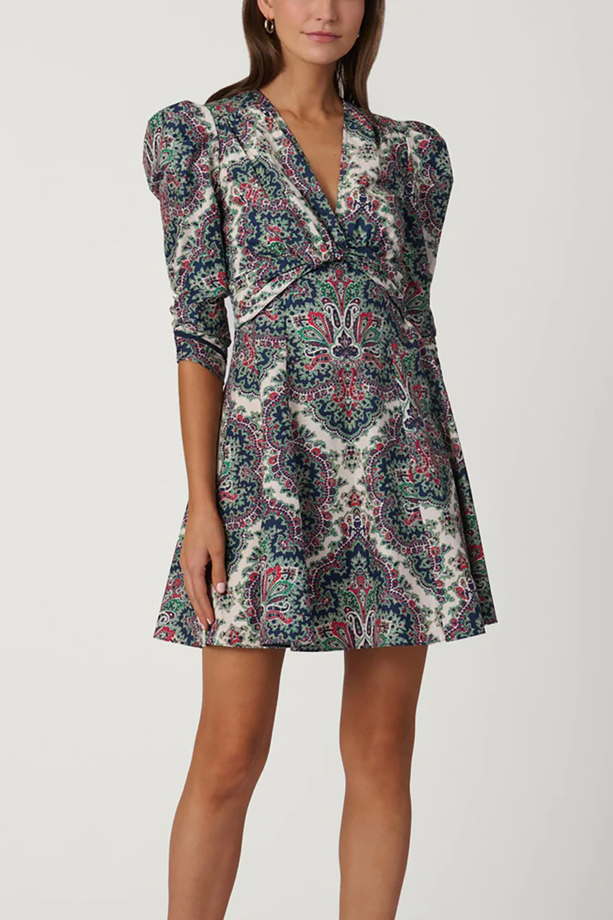 Woman wearing a patterned dress on a white background