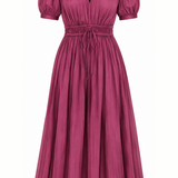A dusty rose pink midi-length pleated dress with short puff sleeves, a V-neckline, and a drawstring waist, shown against a plain white background.