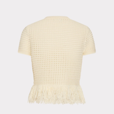 A cream-colored short-sleeve knit top with a textured openwork pattern and a fringed hem, shown from the back against a light gray background.