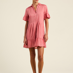 Woman wearing a pink dress on a beige background