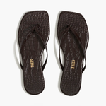 Pair of black flip-flops with 'TKEES' branding on a white background