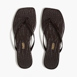 Pair of black flip-flops with 'TKEES' branding on a white background
