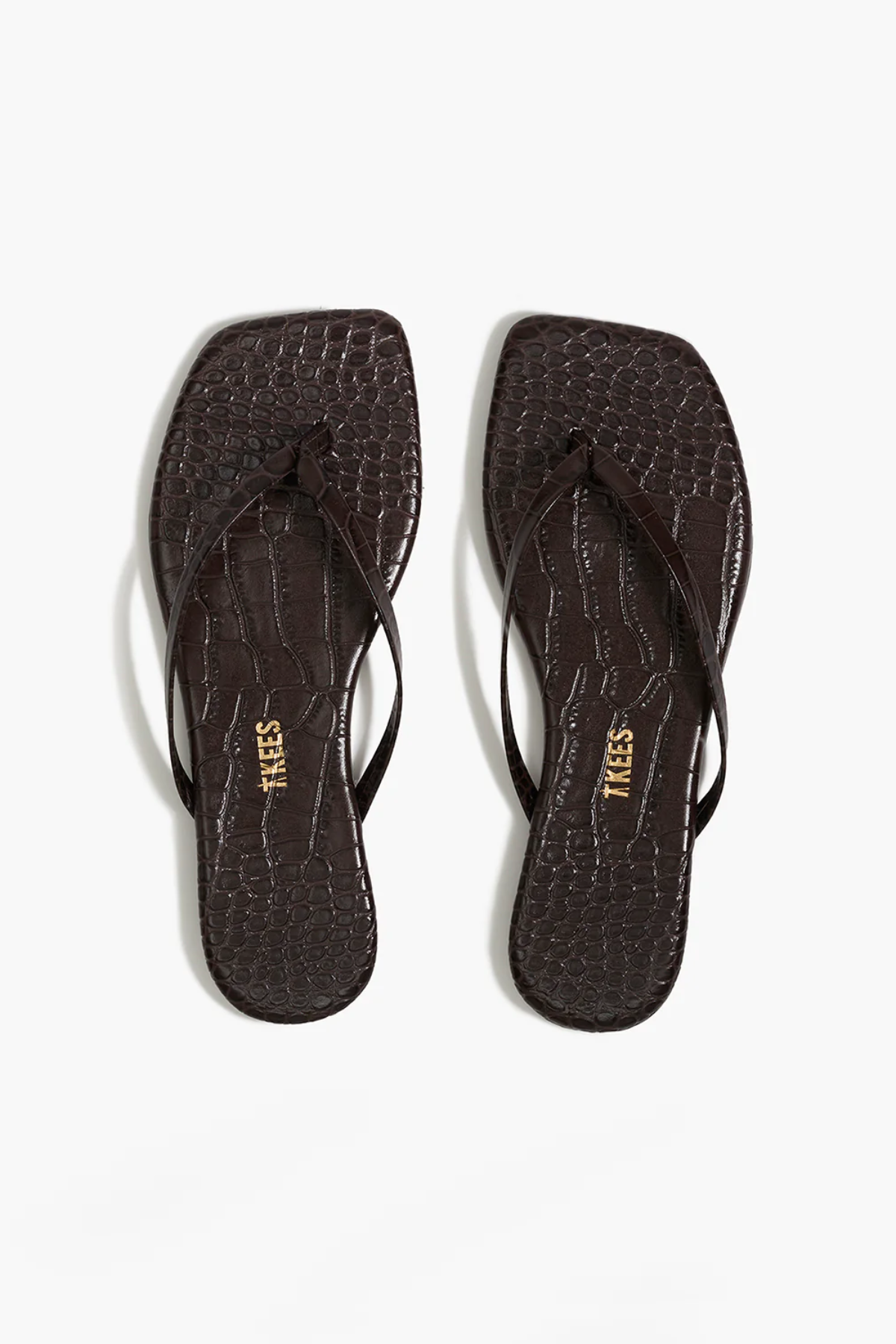 Pair of black flip-flops with 'TKEES' branding on a white background