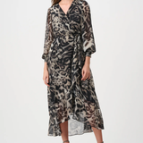 Woman wearing a patterned dress on a white background