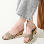 green wedges on woman on white background 