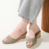 green wedges on woman on white background 