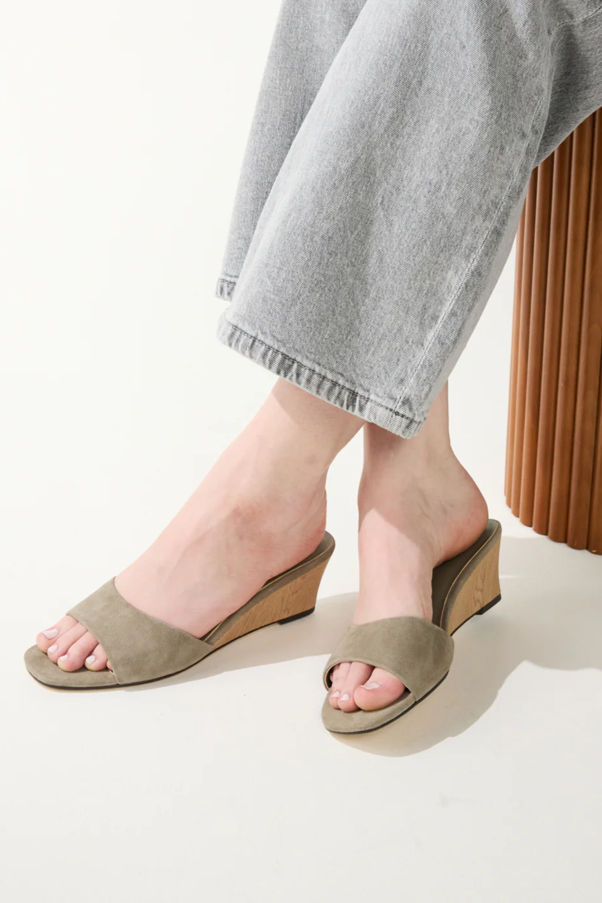 green wedges on woman on white background 